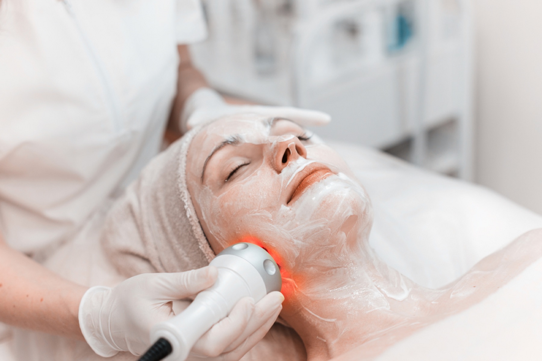 Facial mask and handheld skincare device during a spa treatment