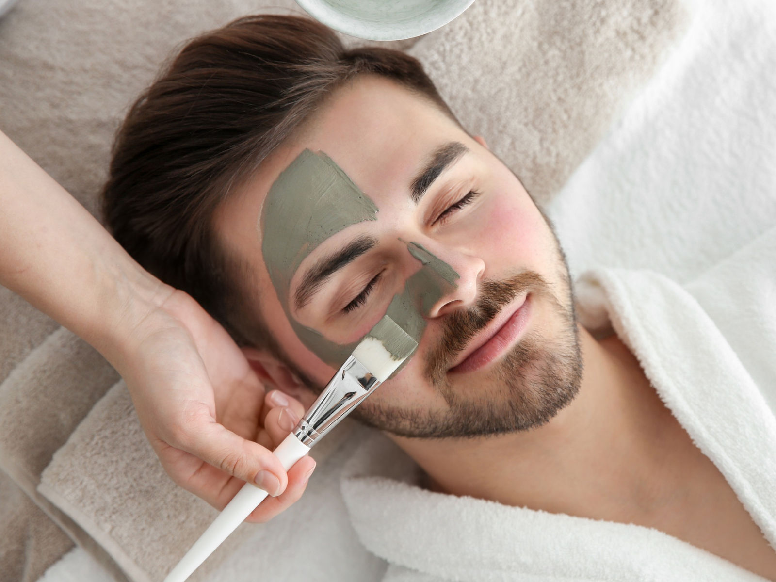 A mask being applied to the face during spa care